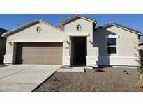 Charming single-story home featuring a two-car garage, a covered porch, and low-maintenance landscaping at 18864 E Bruno Dr, Gold Canyon, AZ 85118