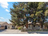 Ranch style home with mature trees and a spacious front yard at 3432 N 86Th Ave, Phoenix, AZ 85037