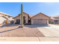 Single-story house with a two-car garage and desert landscaping at 4213 E Stanford Ave, Gilbert, AZ 85234