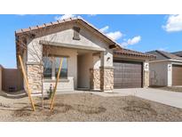 Charming single-story home with desert landscaping, stone accents, and a two-car garage at 7548 W Park St, Laveen, AZ 85339