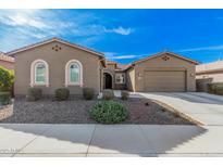 Charming single-story home featuring manicured front yard and a two-car garage at 10501 W Swayback Pass, Peoria, AZ 85383