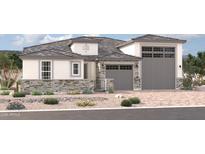 Two-story house with stone accents and a three-car garage at 2344 S 182Nd Dr, Goodyear, AZ 85338