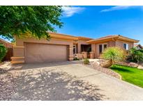 Beautiful single-story home featuring a well-manicured front yard and an attached two-car garage at 42017 N Crooked Stick Rd, Anthem, AZ 85086