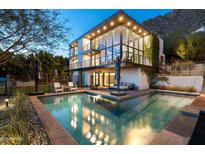 Luxury home with a stunning pool and mountain views at dusk at 5419 E Valle Vista Rd, Phoenix, AZ 85018