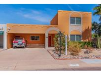 Inviting two-story home boasting an attached covered carport and southwest-inspired architecture at 7844 E Coolidge St, Scottsdale, AZ 85251