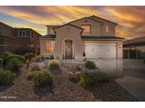 Two-story house with a three-car garage, landscaped yard, and stone accents at 2415 E Hazeltine Way, Gilbert, AZ 85298