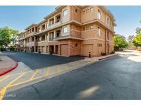 Exterior view of a modern building with attached garages and landscaping at 2989 N 44Th St # 1004, Phoenix, AZ 85018