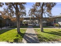 Courtyard with covered patio, seating area, and manicured lawn at 3650 E Montecito Ave # 5, Phoenix, AZ 85018