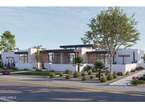 Contemporary home with wood and stone accents, and drought-tolerant landscaping at 8226 E Davenport Dr, Scottsdale, AZ 85260