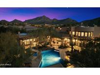 Stunning twilight aerial view of the estate with a backyard pool and mountain views at 10801 E Happy Valley Rd # 102, Scottsdale, AZ 85255