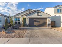 Single-story home with desert landscaping and a two-car garage at 2038 E Dry Wood Rd, Phoenix, AZ 85024