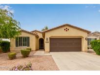 Charming single-story home featuring a brown two-car garage and desert landscaping at 2364 S Minneola Ln, Gilbert, AZ 85295