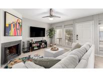 Bright living room with fireplace, large TV, and comfortable seating at 3002 N 70Th St # 210, Scottsdale, AZ 85251