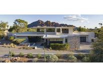 Contemporary home showcasing a modern design with desert landscaping and mountain views at 4451 E Joshua Tree Ln, Paradise Valley, AZ 85253