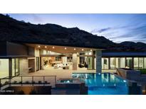 Luxury home with a stunning pool and mountain views at night at 6516 E Meadowlark Ln, Paradise Valley, AZ 85253
