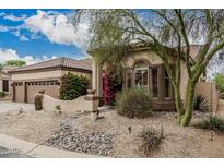 Charming home featuring a desert-landscaped front yard and lush bougainvillea at 7735 E Russell Cir, Mesa, AZ 85207