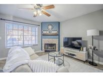 Cozy living room featuring a fireplace and large window at 921 W University Dr # 1045, Mesa, AZ 85201