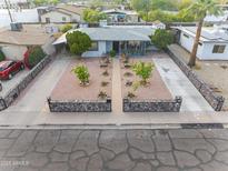 Aerial view of charming home featuring rock-lined yard, mature landscaping, and expansive driveway at 9410 N 4Th Ave, Phoenix, AZ 85021