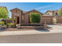 Inviting single-story home featuring a well-maintained front yard and two-car garage at 12541 W Miner Trl, Peoria, AZ 85383