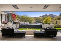 Stunning backyard patio with a fire pit, pool, and mountain views at 27951 N 96Th Pl, Scottsdale, AZ 85262