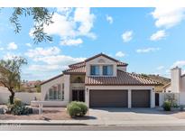 Two-story house with tile roof, two-car garage, and desert landscaping at 3435 E Desert Trumpet Rd, Phoenix, AZ 85044