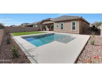 Beautiful backyard with a refreshing pool and well-manicured landscaping and artificial grass at 18509 W Galveston St, Goodyear, AZ 85338