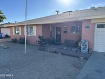 Modest single-story home featuring a low-maintenance gravel yard and covered entry at 4119 W Townley Ave, Phoenix, AZ 85051