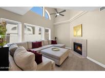Bright living room with vaulted ceilings, fireplace, and large sectional sofa at 5018 E Siesta Dr # 3, Phoenix, AZ 85044