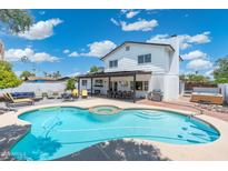 Gorgeous swimming pool and spa, with an outdoor kitchen, and multiple seating areas at 5101 E Winchcomb Dr, Scottsdale, AZ 85254