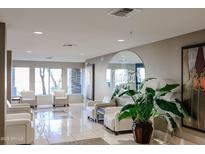 Inviting lobby area with tile floors, comfortable white seating, and ample natural light from large windows at 5450 E Deer Valley Dr # 2193, Phoenix, AZ 85054