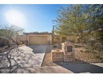 Charming single-story home featuring desert landscaping, attached two-car garage, and stone address pillar at 8442 N 18Th St, Phoenix, AZ 85020