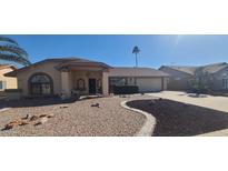 Charming single-story home with a well-maintained desert landscape and a covered porch at 13911 W Gable Hill Dr, Sun City West, AZ 85375