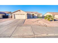 Charming single-story home featuring a two-car garage, desert landscaping, and a quaint front entrance at 1612 E South Mountain Ave, Phoenix, AZ 85042