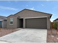 Charming single-story home with a two-car garage and low-maintenance desert landscaping at 17449 W Eva St, Waddell, AZ 85355