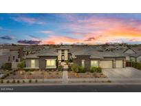 Stunning exterior of a modern home, featuring a neutral color palette, manicured desert landscaping, and a spacious three-car garage at 19726 E Vallejo St, Queen Creek, AZ 85142