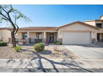 Charming single-story home with desert landscaping, covered porch, and attached two-car garage at 2724 S Chaparral Rd, Apache Junction, AZ 85119