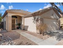 Charming single-story home featuring a tile roof, arched entry, and a two-car garage for convenient parking and curb appeal at 30420 N 43Rd St, Cave Creek, AZ 85331