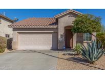 Charming single-story home featuring a tiled roof, two-car garage, and desert landscaping at 3804 W Ashton Dr, Anthem, AZ 85086