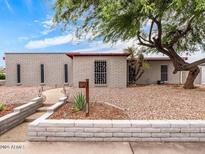 Charming single-story home featuring desert landscaping and a unique brick facade at 4901 W Beverly Ln, Glendale, AZ 85306