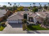 Charming, single-story home boasts a manicured lawn, beautiful desert landscaping, and a three-car garage at 6302 N 4Th Dr, Phoenix, AZ 85013