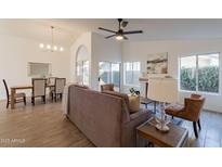 Bright living room featuring tile floors, ceiling fan, fireplace and adjoining dining area at 72 S Willow Creek St, Chandler, AZ 85225