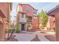 Charming two-story home with stucco exterior, balcony and desert landscaping at 7807 W Palm Ln, Phoenix, AZ 85035