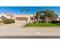 Charming single-story home with a two car garage, desert landscaping, and mature trees at 14158 W Desert Glen Dr, Sun City West, AZ 85375