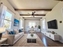 Bright living room with hardwood floors, ceiling beams, and modern furniture at 1541 W Culver St, Phoenix, AZ 85007