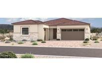 Beautiful single-story home featuring stone accents, a desert landscape, and a brick-paved driveway at 18204 W Ashley Dr, Goodyear, AZ 85338