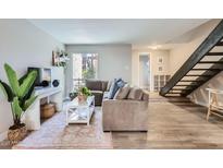 Bright living room with a comfortable sectional sofa, wooden floors and stylish decor at 4525 E Rhonda Dr, Phoenix, AZ 85018