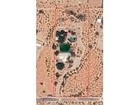 Aerial view of property in desert setting featuring a large pool and private pond at 15076 W Belmont Dr, Casa Grande, AZ 85194