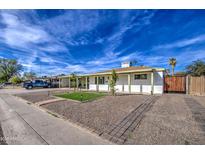 Charming single-story home featuring a well-maintained front yard with desert landscaping and a covered carport at 2926 W Echo Ln, Phoenix, AZ 85051
