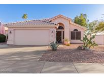 Charming single-story home featuring desert landscaping and a two-car garage at 3403 E Kristal Way, Phoenix, AZ 85050