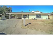 Single-story home featuring a spacious carport and desert landscaping at 4716 W State Ave, Glendale, AZ 85301